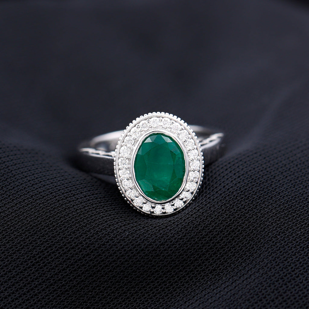 1.2 Carat Oval Lab Grown Emerald Bezel Set Engagement Ring With Diamond Halo