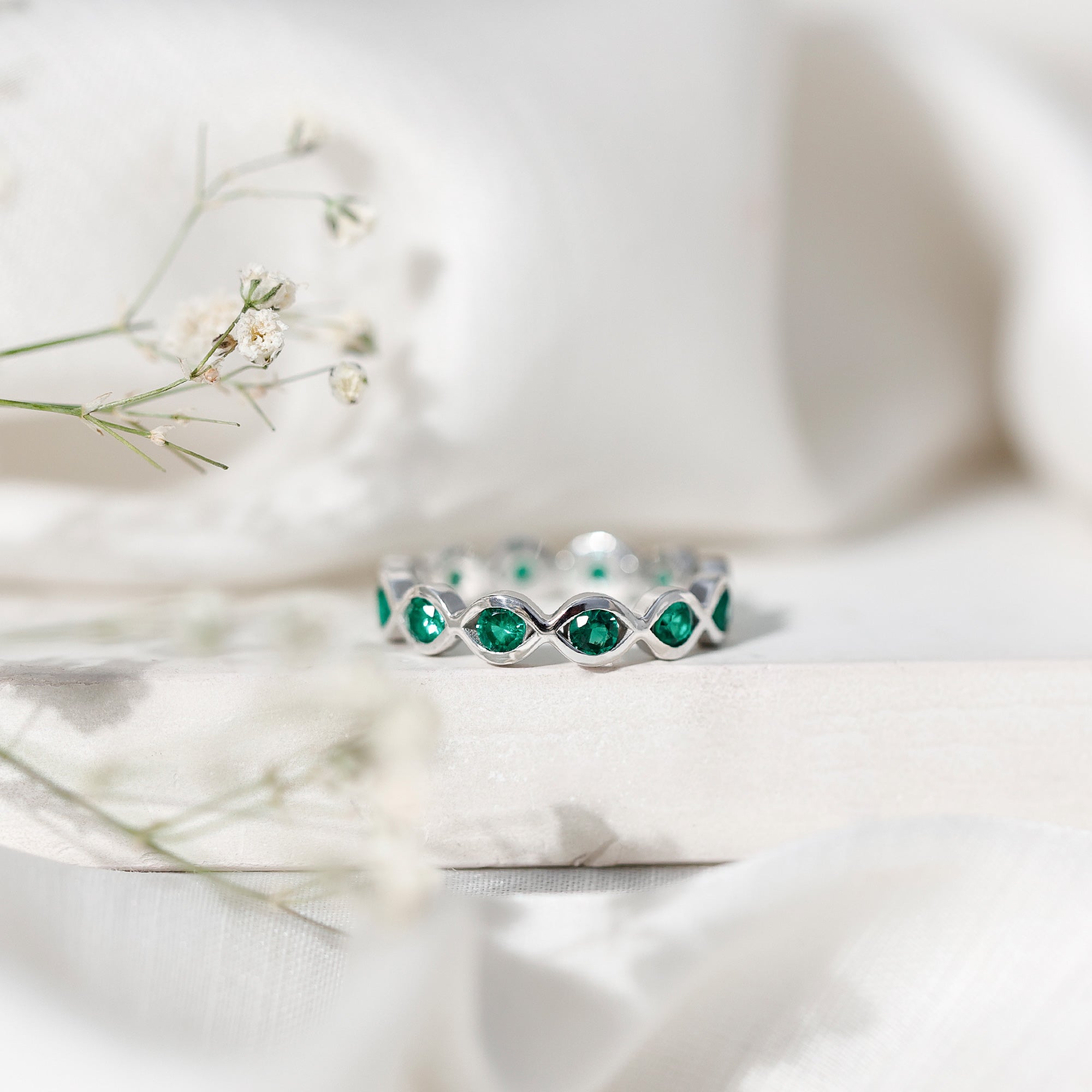 Certified Lab Grown Emerald Infinity Twisted Eternity Ring